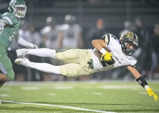  ?? Steph Chambers/Post-Gazette ?? Belle Vernon’s Larry Callaway leaps for more yardage against South Fayette in the WPIAL Class 4A semifinals Friday night.