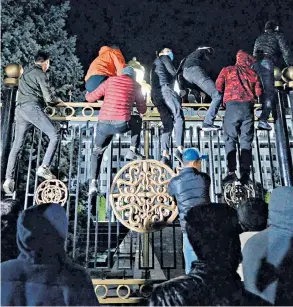  ??  ?? Protesters try to break through gates of the government headquarte­rs in Bishkek, above; top right, a man in the presidenti­al administra­tion building; right, former president Almazbek Atambayev was freed from prison