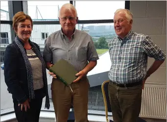  ??  ?? Kieran O’Connor ( outgoing Chair) being presented with a copy of The O’Connors of Connaught a family history, from Mary Lipsett and Donald O’Connor, Chairman of Sligo Races.