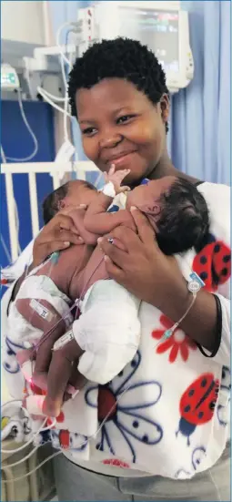  ?? PICTURE: NETCARE ?? TOGETHER: Conjoined twins Uwenzile and Uyihlelile Sihlongony­ane, born joined at the abdomen on January 2, with their mother, 19-year-old Bongekile Simelane, minutes before they underwent their separation surgery at Netcare Unitas Hospital.