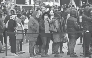  ?? SETH WENIG/AP ?? People wait in a long line Monday to get tested for the coronaviru­s in New York City’s Times Square.