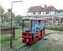  ?? PETER NICHOLSON ?? Howard Burford driving tram No. 96 on the Wootton Electric Tramway garden line. Power, at 40V, was supplied by an overhead wire, the current passing through on-board batteries. These could be charged, as well as ensuring direct supply to the motor was constant. The traction standard and stop sign is portable, as this section of track was taken to events as required.