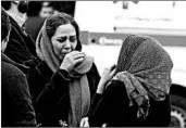  ?? ATTA KENARE/GETTY-AFP ?? Relatives of passengers aboard Aseman Airlines Flight EP3704 gather Sunday near Tehran’s Mehrabad Airport.