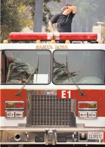  ?? Noah Berger / Special to The Chronicle ?? Top: A primary school classroom at St. Rose School is seen with damages caused by the Tubbs Fire in Santa Rosa. Above: Santa Rosa firefighte­r Jessie Taintor prepares to fight the Tubbs Fire in the Oakmont area.