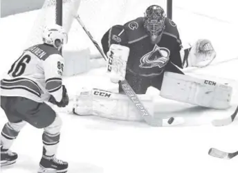  ??  ?? Colorado Avalanche goalie Semyon Varlamovma­kes one of his 57 saves in Thursday night’s 5- 3 victory over the Carolina Hurricanes at the Pepsi Center in Denver.