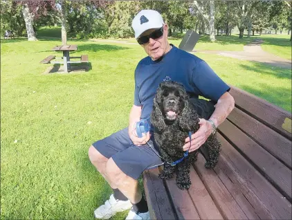  ?? NEWS PHOTO GILLIAN SLADE ?? Rod Canham takes a short break from his walk with Rayne, 7, at Echo Dale Regional Park Monday. It was a busy August long weekend for Hatters and the Medicine Hat Police Service, with people spending as much time as possible in the sun, and police...