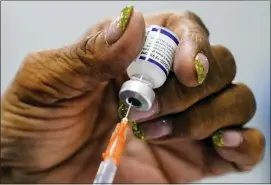  ?? MATT ROURKE — THE ASSOCIATED PRESS ?? A syringe is prepared with the Pfizer Covid-19vaccine at a vaccinatio­n clinic at the Keystone First Wellness Center in Chester, Pa., Wednesday.