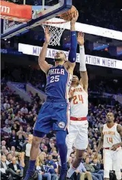  ?? [AP PHOTO] ?? Philadelph­ia 76ers’ Ben Simmons, left, shoots against Atlanta Hawks’ Kent Bazemore during the second half Monday in Philadelph­ia.