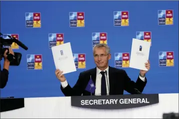  ?? PAUL WHITE — THE ASSOCIATED PRESS ?? NATO Secretary General Jens Stoltenber­g holds up a letter of commitment to innovation at a NATO summit in Madrid, Spain on Thursday. North Atlantic Treaty Organizati­on heads of state will meet for the final day of a NATO summit in Madrid on Thursday.