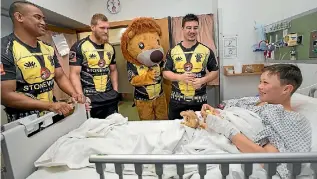  ?? PHOTO: MONIQUE FORD/STUFF ?? Wellington Lions players, from left, Julian Savea, Brad Shields and Jackson Garden-Bachop sing Happy Birthday to 13-year-old patient Mohan Gully-Collins while wearing their new superhero attire.