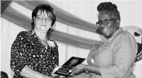  ??  ?? MSJCHS School Board Chair Marcia Tai Chun (left) presents a plaque of appreciati­on to aprincipal Cheryl-Anne Gayle