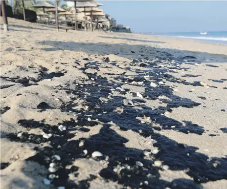  ?? Chris Whiteoak / The National ?? Oil washed up on a beach in Fujairah. Fishermen blamed tanker captains and urged the authoritie­s to act