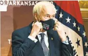  ?? STACI VANDAGRIFF AP ?? Arkansas Gov. Asa Hutchinson has mandated the wearing of masks in public, but some police department­s are refusing to enforce his order.