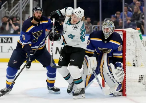  ?? Elsa/Getty Images ?? Marcus Sorensen of San Jose, center, collides with Robert Bortuzzo of St. Louis, left, as Blues goalie Jordan Binnington watches in the third period Friday at Enterprise Center in St Louis.