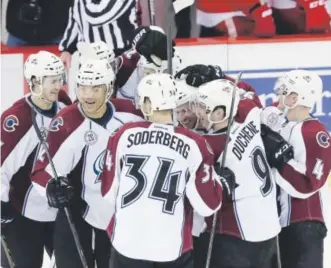 ??  ?? Avalanche players including Carl Soderberg and Matt Duchene celebrate Friday night after posting a 3- 2 shootout victory over the RedWings in Detroit. Carlos Osorio, The Associated Press
