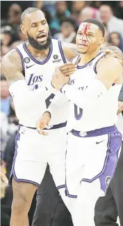  ?? RONALD CORTES/AGENCE FRANCE-PRESSE ?? LEBRON James of the Los Angeles Lakers checks on teammate Russell Westbrook after getting hit by Zach Collins of the San Antonio Spurs during their NBA game. The Lakers won, 143-138.