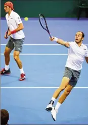  ??  ?? Jan-Lennard Struff (L) and Tim Puetz of Germany hit a return during their World Group Davis Cup tennis third round doubles match against Matthew Ebden and John Peers of Australia at Pat Rafter Arena in Brisbane on Saturday.