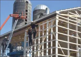  ?? PETE BANNAN — MEDIANEWS GROUP ?? Amish workers and their neighbors, rebuild a dairy barn which was destroyed in a devastatin­g fire early Wednesday morning.