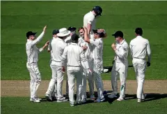  ?? PHOTOS: GETTY IMAGES ?? Trent Boult leaves the field after taking six wickets and, right, fellow opening bowler Tim Southee celebrates after taking Jonny Bairstow’s wicket.