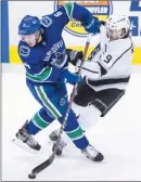  ?? The Canadian Press ?? Vancouver Canucks forward Brock Boeser, left, collides with Adrian Kempe of the Los Angeles Kings during Tuesday’s game.