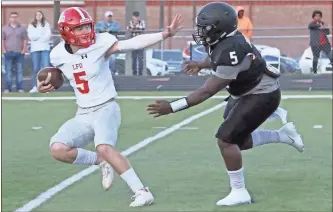  ?? Scott Herpst ?? Ridgeland’s Ashton Turner tries to chase down LFO quarterbac­k Will Carroll during Friday’s scrimmage, which closed out spring practice for both teams.