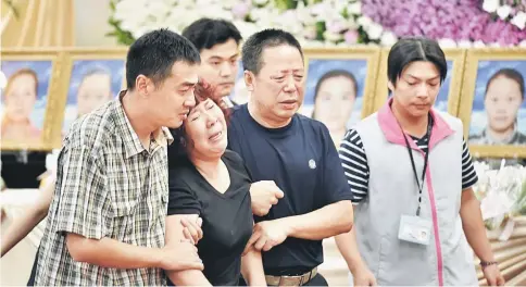  ??  ?? Chinese relatives mourn the loss of victims at Chungli funeral parlour in Taoyuan. — AFP photo