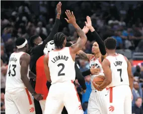  ?? AP PHOTO ?? Danny Green of the Toronto Raptors, second from right, celebrates his game-winning shot against the Orlando Magic with teammates Pascal Siakam, Kawhi Leonard and Kyle Lowry on Tuesday night in Orlando, Fla.