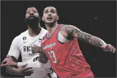  ?? BEBETO MATTHEWS/AP ?? BROOKLYN NETS FORWARD MARKIEFF MORRIS (LEFT) and Washington Wizards forward Kyle Kuzma jostle for a rebound during the game on Saturday.