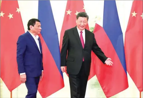  ?? KENZABURO FUKUHARA/AFP ?? Philippine President Rodrigo Duterte (left) is shown the way by Chinese President Xi Jinping before their meeting at the Great Hall of People in Beijing on April 25.