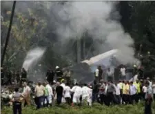  ?? ENRIQUE DE LA OSA — THE ASSOCIATED PRESS ?? Cuba’s President Miguel Diaz-Canel, third from left, walks away from the site where a Boeing 737 plummeted into a yuca field with more than 100 passengers on board, in Havana, Cuba, Friday. The Cuban airliner crashed just after takeoff from Havana’s...