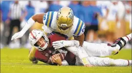  ?? ?? DATONA JACKSON sacks Stanford quarterbac­k Tanner McKee during the second half of the Bruins’ 35-24 road victory over the Cardinal.