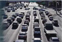  ?? AP FILE PHOTO/JOHN LOCHER ?? Cars wait at a red light during rush hour in Las Vegas.