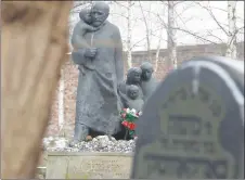  ?? AP PHOTO ?? Flowers are placed at the memorial to Janusz Korczak, who died in the gas chamber of the Treblinka Nazi German death camp in 1942, together with the children of the Jewish orphanage that he ran in the Warsaw Ghetto, at the Jewish cemetery in Warsaw,...