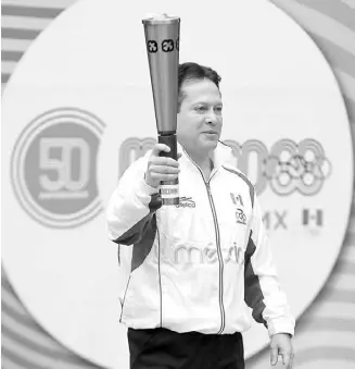  ??  ?? El exatleta mexicano Daniel Aceves Villagrán sostiene la llama olímpica. EFE