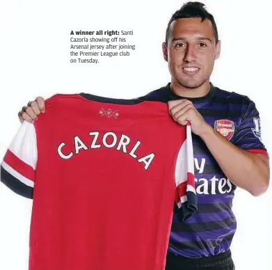  ??  ?? A winner all right: Santi Cazorla showing off his Arsenal jersey after joining the Premier League club on Tuesday.