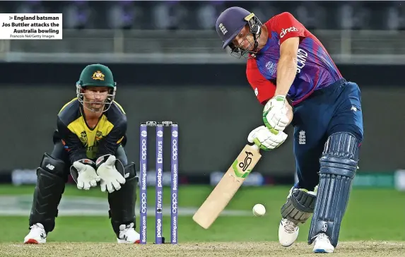  ?? Francois Nel/Getty Images ?? > England batsman Jos Buttler attacks the
Australia bowling