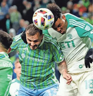  ?? JOE NICHOLSON/USA TODAY ?? Seattle Sounders forward Jordan Morris, left, battles for a header against Austin FC defender Julio Cascante during the second half of Saturday night's 0-0 draw at Lumen Field.