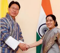  ?? AFP ?? Indian External Affairs Minister Sushma Swaraj greets Bhutanese Foreign Minister Damcho Dorji ahead of a bilateral meeting in Kathmandu on Friday. —