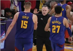  ?? AP PHOTO/MARK J. TERRILL ?? Denver Nuggets head coach Michael Malone, center, shakes hands with Denver Nuggets center Nikola Jokic (15) and guard Jamal Murray (27) in the second half of Game 3 of the NBA basketball Western Conference Final series against the Los Angeles Lakers Saturday, May 20, 2023, in Los Angeles.