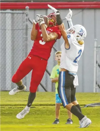  ?? STAFF PHOTO BY DOUG STRICKLAND ?? Lakeview-Fort Oglethorpe’s Ruddy Ware, left, catches a touchdown pass ahead of Ringgold’s Bryton McCann during Friday’s game in Fort Oglethorpe. LFO won 35-25.