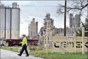  ??  ?? Cemex employee Dan Ellsworth walks across the entrance road at The Cemex Cement Plant in Lyons, Colo. on Tuesday.