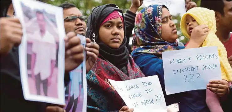  ?? AFP PIC ?? People gathering to find out informatio­n about a man missing after the mosque shootings in Christchur­ch, New Zealand, on Sunday.