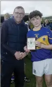  ??  ?? Carnew’s Daniel Redmond is presented with his Wicklow Peo