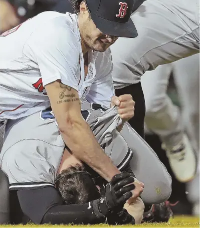  ?? STAFF PHOTO BY MATT STONE ?? NO HOLDS BARRED: Joe Kelly lands a right hand to the back of Tyler Austin’s head during a brawl in the seventh inning of the Red Sox’ 10-7 loss to the Yankees last night at Fenway Park.