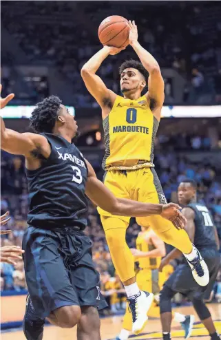  ?? JEFF HANISCH / USA TODAY SPORTS ?? Marquette Golden Eagles guard Markus Howard shoots over Xavier Musketeers guard Quentin Goodin.