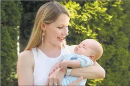  ?? Ned Gerard / Hearst Connecticu­t Media ?? Nora Goddard poses with her son, Elias, at her family’s home in Fairfield on Thursday. Elias, Goddard’s first child, was born in April.