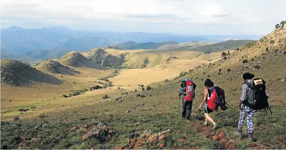  ??  ?? FOLLOW THE LEADER: Sibusiso Vilane, Claire Keeton and Dudu Mathebula head into the hills of the Malolotja Nature Reserve in Swaziland