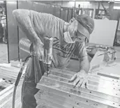  ?? LIBBY MARCH/THE NEW YORK TIMES ?? A worker at Cameron Manufactur­ing, which briefly shut down because of the pandemic, in Horseheads, New York.