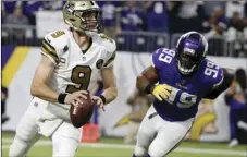  ?? AP PHOTO/ BRUCE KLUCKHOHN ?? New Orleans Saints quarterbac­k Drew Brees runs from Minnesota Vikings defensive end Danielle Hunter (right) during the second half of an NFL football game, on Sunday, in Minneapoli­s.