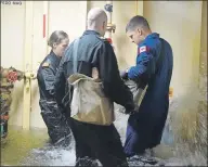  ?? JONATHAN RILEY/TC MEDIA ?? Canadian astronaut Jeremy Hansen, right, and two members of the Canadian Forces work together to stop the leaks in a flooding simulator at the Kootenay Damage Control Training Facility near Halifax.